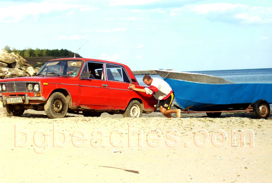 With a little help, one of USSR's best selling cars - Lada 1600 not only goes through the sands but also pulls a boat behind.